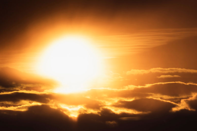 A hazy sunset over the clouds